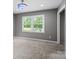 Neutral bedroom featuring a large window and ample natural light at 895 Furnace Rd, Iron Station, NC 28080