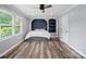 Modern bedroom with built-in shelving, recessed lighting, and stylish wood-look floors at 895 Furnace Rd, Iron Station, NC 28080