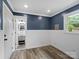 Stylish bedroom with wood-look floors, and a beautifully remodeled ensuite bathroom at 895 Furnace Rd, Iron Station, NC 28080