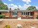 Relaxing front porch with brick features and cozy outdoor seating area at 895 Furnace Rd, Iron Station, NC 28080