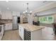 Open concept kitchen featuring a wine cooler and a large island with granite countertops at 895 Furnace Rd, Iron Station, NC 28080