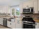 Stainless steel appliances, granite countertops, and a breakfast bar at 895 Furnace Rd, Iron Station, NC 28080