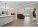 Bright open living area featuring modern lighting, fireplace, and luxury vinyl flooring at 895 Furnace Rd, Iron Station, NC 28080