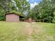View of the outbuildings and recreational covered area on grassy lawn, perfect for entertaining guests at 895 Furnace Rd, Iron Station, NC 28080