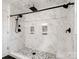 Modern shower featuring white marble tiling and sleek black hardware at 895 Furnace Rd, Iron Station, NC 28080