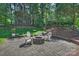 Landscaped backyard with paver patio, charming fire pit, and plenty of greenery at 9209 Cameron Wood Dr, Charlotte, NC 28210
