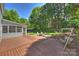 Spacious deck and patio with fire pit, swing set, and serene backyard views at 9209 Cameron Wood Dr, Charlotte, NC 28210