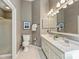 Well-lit bathroom with double sinks, large mirror, and clean fixtures, providing a functional and stylish space at 9209 Cameron Wood Dr, Charlotte, NC 28210
