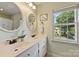 Bathroom with dual vanity and a window offering plenty of natural light at 9209 Cameron Wood Dr, Charlotte, NC 28210