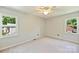 Bright bedroom featuring fresh paint and natural light from two windows at 9209 Cameron Wood Dr, Charlotte, NC 28210