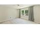 Neutral bedroom with plush carpeting and a large window draped with stylish curtains at 9209 Cameron Wood Dr, Charlotte, NC 28210