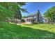 The back of the house overlooks the spacious, beautifully landscaped yard and a patio area at 9209 Cameron Wood Dr, Charlotte, NC 28210
