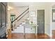 Inviting foyer features hardwood floors, staircase with black railings, and a decorative console table at 9209 Cameron Wood Dr, Charlotte, NC 28210
