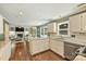 Spacious open-concept kitchen with granite countertops, stainless appliances, a breakfast nook, and backyard views at 9209 Cameron Wood Dr, Charlotte, NC 28210