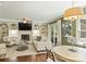 An open-concept living room and kitchen space featuring built-ins surrounding the fireplace and hardwood floors at 9209 Cameron Wood Dr, Charlotte, NC 28210