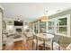 An open-concept living room and kitchen space featuring hardwood floors and ample natural light at 9209 Cameron Wood Dr, Charlotte, NC 28210