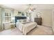 Bright main bedroom with a plush bed, blue accents, and ample natural light from the surrounding windows at 9209 Cameron Wood Dr, Charlotte, NC 28210