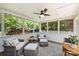 Inviting screened-in porch with wicker seating and a view of the lush backyard at 9209 Cameron Wood Dr, Charlotte, NC 28210