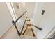 Carpeted staircase featuring a dark handrail and white risers, providing a classic and elegant transition at 9209 Cameron Wood Dr, Charlotte, NC 28210
