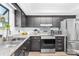 Updated kitchen with granite countertops, stainless steel appliances, and dark cabinets at 9214 N Vicksburg Park Ct, Charlotte, NC 28210