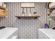 Well-organized laundry room with washer, dryer, and patterned wallpaper at 9214 N Vicksburg Park Ct, Charlotte, NC 28210