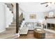 Inviting living room with stairs, fireplace, modern furniture, and beautiful wood floors at 9214 N Vicksburg Park Ct, Charlotte, NC 28210