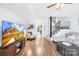 Bright living room featuring wood floors, a ceiling fan, and staircase at 9214 N Vicksburg Park Ct, Charlotte, NC 28210