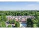 Apartment complex aerial view highlighting parking, a pool, and skyline views at 1000 E Woodlawn Rd # 402, Charlotte, NC 28209