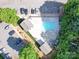 Overhead view of a community pool with ample parking and surrounding green trees at 1000 E Woodlawn Rd # 402, Charlotte, NC 28209