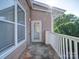 View of balcony with white railing, door, and view of trees at 1000 E Woodlawn Rd # 402, Charlotte, NC 28209