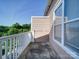 View of balcony with white railing and beige siding and view of trees at 1000 E Woodlawn Rd # 402, Charlotte, NC 28209