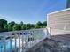 Relax on the balcony with a community pool view and wooded perimeter, perfect for unwinding outdoors at 1000 E Woodlawn Rd # 402, Charlotte, NC 28209