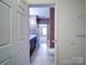 View through doorway of ensuite bathroom with dark cabinets and white trim at 1000 E Woodlawn Rd # 402, Charlotte, NC 28209