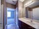 Bathroom vanity, large mirror, and doorway to bedroom at 1000 E Woodlawn Rd # 402, Charlotte, NC 28209