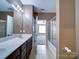Bathroom with double vanity, sliding glass shower doors, and access to bedroom at 1000 E Woodlawn Rd # 402, Charlotte, NC 28209