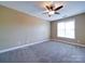 Bedroom featuring neutral walls, ceiling fan and a bright window at 1000 E Woodlawn Rd # 402, Charlotte, NC 28209