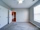Bedroom featuring neutral walls, carpet and a large closet at 1000 E Woodlawn Rd # 402, Charlotte, NC 28209