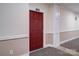 Apartment 402's red entry door in carpeted hallway with neutral walls at 1000 E Woodlawn Rd # 402, Charlotte, NC 28209
