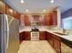 The modern kitchen boasts granite countertops, stainless steel appliances, and rich wood cabinets at 1000 E Woodlawn Rd # 402, Charlotte, NC 28209