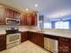Bright kitchen features stainless appliances, granite countertops, and wood cabinets overlooking an adjacent living room at 1000 E Woodlawn Rd # 402, Charlotte, NC 28209