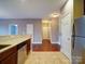 Open kitchen design with breakfast bar offering stainless steel appliances and views into the dining and living areas at 1000 E Woodlawn Rd # 402, Charlotte, NC 28209