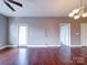 Spacious open living area with hardwood floors and views of adjacent rooms and natural light at 1000 E Woodlawn Rd # 402, Charlotte, NC 28209