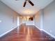 Open living space showcases hardwood floors, a ceiling fan, and ample natural light at 1000 E Woodlawn Rd # 402, Charlotte, NC 28209