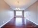 Bright open floorplan features hardwood flooring, modern lighting, and large windows at 1000 E Woodlawn Rd # 402, Charlotte, NC 28209