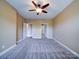 Spacious main bedroom features neutral walls, plush carpet, and a ceiling fan at 1000 E Woodlawn Rd # 402, Charlotte, NC 28209