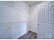 Bright walk-in closet featuring white walls, shelving and neutral carpet at 1000 E Woodlawn Rd # 402, Charlotte, NC 28209