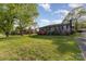 Beautiful home with a spacious lawn and mature trees, offering a serene and inviting outdoor setting at 1009 N Main St, Mount Holly, NC 28120