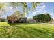 Charming single-story home with a lush green lawn and mature trees at 1009 N Main St, Mount Holly, NC 28120