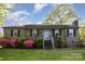 Charming brick home featuring a well-maintained lawn and flowering shrubs, creating a welcoming curb appeal at 1009 N Main St, Mount Holly, NC 28120