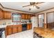 Traditional kitchen with wood cabinetry, tile floors, and essential appliances, plus adjacent dining area at 1009 N Main St, Mount Holly, NC 28120